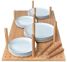 several plates are stacked on top of each other with wooden pegs to hold them