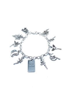 "New. This Bracelet makes a perfect gift  has 11 Fairy themed Charms Stainless Steel bracelet has a lobster clasp closure measures approx 8\" bracelet and charms are silver tone alloy and steel. Charms measure approx 1/2\" - 1\" in size Charms include 10 assorted Fairies and center charm reads Fairies Are Real" Themed Silver Charm Bracelet, Silver Fairycore Bracelet Gift, Whimsical Silver Charm Bracelet, Fairy Jewelry Bracelet, Whimsical Silver Dangling Charms, Whimsical Nickel-free Silver Charm Bracelet, Charm Bracelet Fairy, Fairy Charms, Christmas Jesus