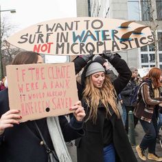 two women holding signs and standing in the street