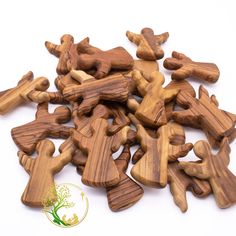 small wooden cutouts of people and animals on a white background with the words wood