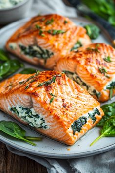 Stuffed salmon fillets with spinach and creamy filling on a plate. Salmon Recipes With Cream Cheese, Salmon Cream Cheese Recipes, Stuffed Salmon Recipes Baked, Stuffed Salmon Side Dishes, Stuffed Salmon Rolls Recipes, Stuffed Salmon Recipes Spinach Baked, Blackened Salmon Stuffed With Spinach And Parmesan Cheese, Pumpkin Salmon, Stuff Salmon With Spinach