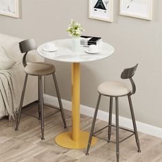 a small table with two stools next to it