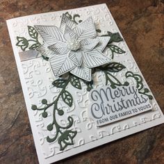 a christmas card with a poinsetti on it