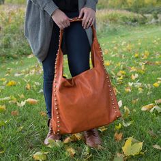 PREMIUM QUALITY: Large bag, packaged in a plastic polybag, is made from polyester and vegan suede and features a snap closure and two handles. IN-HOUSE DESIGN: Metal studs surround the exterior rim of the bag. Interior features three pockets: two open and one zippered. CARE INSTRUCTIONS: Wipe clean with a damp cloth. Fall Over, Large Bag, Burnt Orange, Cleaning Wipes, Rust, Handles, Purse, Exterior, Zipper