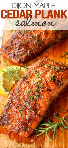 grilled salmon on a wooden cutting board with lemon wedges and rosemary garnish