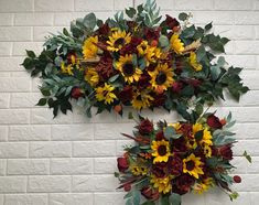 two sunflowers and other flowers are hanging on the wall next to each other