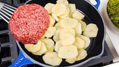 a frying pan filled with meat and sliced apples