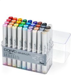 the copic sketch markers are in a clear holder