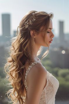 a woman with long hair wearing a wedding dress in front of a cityscape