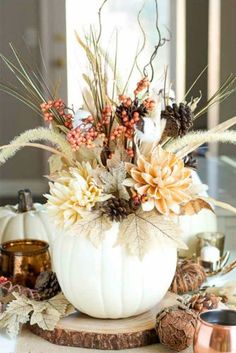 a white pumpkin filled with lots of flowers