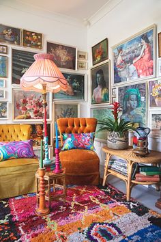 a living room filled with furniture and pictures on the wall