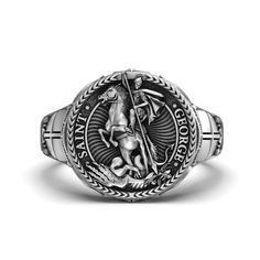 Silver St. George and the Dragon Ring - Medieval Knight Jewelry, Christian Symbol, Unique Men's Ring, Heroic Gift Celebrate the legendary tale of bravery and faith with our Silver St. George and the Dragon Ring. This unique piece of jewelry captures the heroic battle between St. George and the dragon, symbolizing courage and triumph over evil. Crafted from high-quality silver, this ring is perfect for those who appreciate medieval themes and Christian symbolism. Ideal as a unique men's ring or a Knight Jewelry, Christian Symbolism, St George And The Dragon, Saint George And The Dragon, Unique Mens Rings, Dragon Ring, Christian Symbols, Medieval Knight, St George