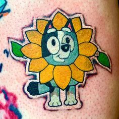 a close up of a person's leg with a tattoo on it and an image of a sunflower