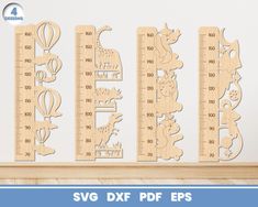 wooden rulers with animals and giraffes on them are shown in front of a white wall