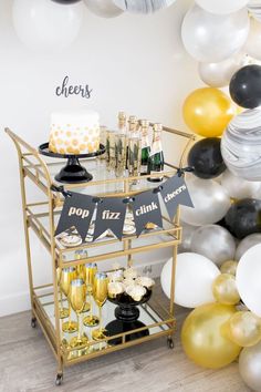 a bar cart filled with drinks and balloons