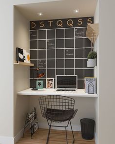 a desk with a blackboard on the wall behind it