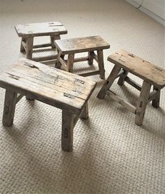 three wooden benches sitting on top of a carpeted floor