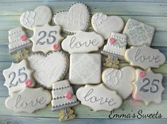 decorated cookies are arranged in the shape of hearts and love letters on a blue background