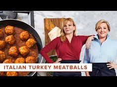 two women standing in front of a pan full of meatballs with the words italian turkey meatballs