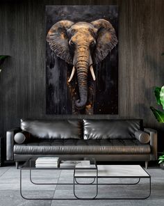 an elephant's head is shown on the wall above a black leather couch in this modern living room