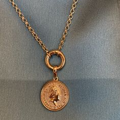 Fine casting made Queen Elizabeth inspired coin pendant in 18k gold filled. A great addition for those looking to have many pendants in a necklace or even bracelet. You may create your own collection, exploring the possibilities of jewelry making or diy (do it yourself) jewelry. Size with bail: 1" length Coin diameter: 0.75 inches Hypoallergenic jewelry Guarantee against tarnish Water resistant Rigorously manufactured under CA Prop 65 and EU standards Made in Brazil Have available the best jewel Nickel-free Yellow Gold Coin Necklace With Round Pendant, Gold Coin Necklace With Charms Pendant, Gold Coin Necklace With Charms In Brass, Gold Coin Necklace With Charms, Yellow Gold Coin Necklace With Nickel-free Round Pendant, Gold Round Medallion Necklace With Charms, Gold Coin Necklace Nickel Free, Gold Coin-shaped Nickel-free Necklace, Nickel Free Gold Round Disc Coin Necklace