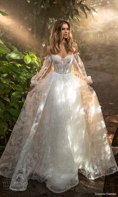 a woman in a white wedding dress standing outside