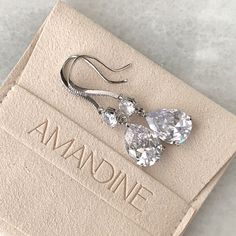 Our Iris earrings are a classic teardrop shape in a slightly longer length to perfectly frame the face. Tiny crystals are embedded into the french hook frames for additional sparkle. Length: 1 3/4", Width 1/2" Pear stones measures 14mm x 10mm 9 carat total weight Carat total weight based on diamond equivalent Custom gift box and microfiber storage pouch included Elegant Crystal Teardrop Earrings For Formal Occasions, Formal Pear-shaped Drop Earrings With Matching Set, Glamorous Teardrop Crystal Earrings For Gift, Teardrop Cubic Zirconia Bridal Earrings, Classic Teardrop Earrings For Wedding, Classic Crystal Teardrop Bridal Earrings, Classic Teardrop Crystal Earrings, Elegant Teardrop Earrings With French Hook, Elegant Teardrop Pendant Crystal Earrings