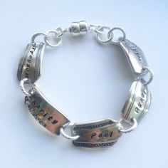 a silver bracelet with two charms on it