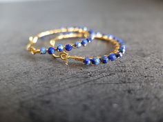 These beautiful fine hoop earrings have beautiful faceted blue Lapis Lazuli and gold filled wire . The gemstones are deep blue color. The genuine beads are wire wrapped around gold filled hoops. the gemstones are faceted genuine lapis lazuli and they are completely handwrapped by me with gold filled wire Diameter of the hoops is 3,00 cm- total diameter is 3.50 cm The round shaped, faceted stones measure 2.5 mm approximately please note that you will receive the exact stones of the photes above T Blue Small Hoop Wire Wrapped Earrings, Blue Wire Wrapped Small Hoop Earrings, Small Blue Wire Wrapped Hoop Earrings, Handmade Blue Hoop Earrings In 14k Gold Filled, Handmade Blue 14k Gold Filled Hoop Earrings, Blue Nickel-free 14k Gold-filled Hoop Earrings, Blue Wire Wrapped Hoop Earrings As Gift, Blue Wire Wrapped Hoop Earrings For Gift, Blue 14k Gold Filled Hoop Jewelry