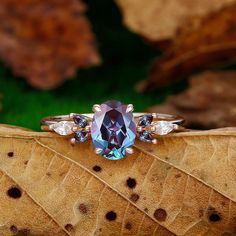 a blue ring sitting on top of a leaf