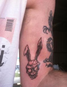 two men with tattoos on their arms and one has a rabbit's head in the middle