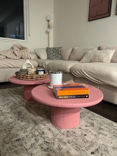 a pink coffee table sitting on top of a rug in a living room next to a couch