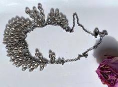 "Beautiful and authentic swan marked Swarovski silver and crystal bib necklace. Crystals are of a very light smokey romantic color. The length is adjustable, can be anything from 15.5\" to 17.5\". Versatile, feminine and elegant, it can dress up any outfit. It has multiple tear drop faceted crystals hanging on a silver chain. An additional silver chain is mounted to hang below the crystals. The necklace has a lobster clasp with a swan on it, and a small swan tag with round crystals and another s Silver Drop Necklaces With Rhinestones, Silver Drop Necklace With Rhinestones, Silver Drop Necklaces For Evening, Silver Drop Necklace For Evening, Glamorous Silver Teardrop Necklace, Crystals Hanging, Swan Logo, Romantic Colors, Golden Hair