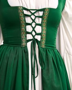 This costume set is perfect for the Renaissance Faire, featuring a 2-piece Irish dress and long-sleeved chemise. THE IRISH DRESS Get a perfect fit with the lace-up details on the bodice and shoulders of this dress. The brocade trim adds a beautiful touch, and the soft cotton-blend material is super comfy. Customize your fit with the adjustable back laces. THE MYTHIC STYLE CHEMISE Two flouncy flounces below the waist, charming long sleeves with mystical cuffs. One-size to be cinched down by overd Beautiful Sorceress, Halloween Gown, Irish Costumes, Irish Dress, Plain Skirt, Plain Dress, Medieval Dress, Fairy Costume, Cream Dress