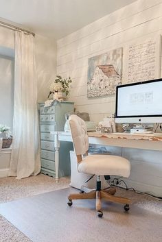 a white desk with a computer on top of it and a chair next to it