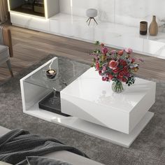 a white coffee table with flowers on top