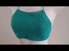 a woman's green bra top on a mannequin headdress with crochet