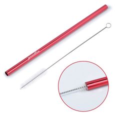 a red ballpoint pen next to a metal straw