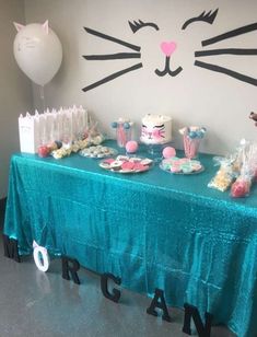 a cat themed birthday party with cake and cupcakes