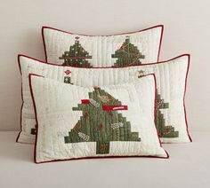 three pillows with christmas trees on them