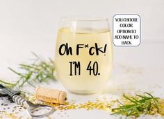 a wine glass with corks on it and the words oh f k i m 50