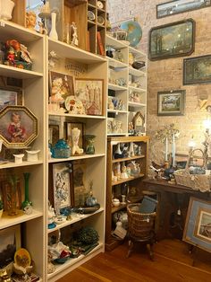 a room filled with lots of shelves covered in pictures and figurines on top of them