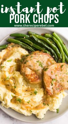 a plate with mashed potatoes, green beans and pork chops covered in gravy