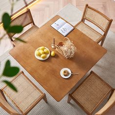 an overhead view of a dining room table and chairs with plates of food on it