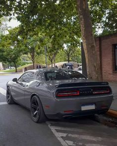 a gray sports car is parked on the street