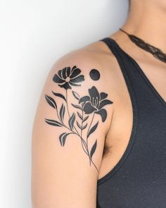 a woman with a flower tattoo on her arm