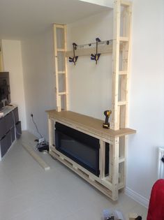 an unfinished entertainment center in the middle of a living room