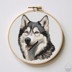 a cross stitch picture of a husky dog