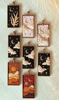 six square pendants with different designs on them