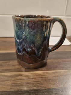 a coffee cup sitting on top of a wooden table